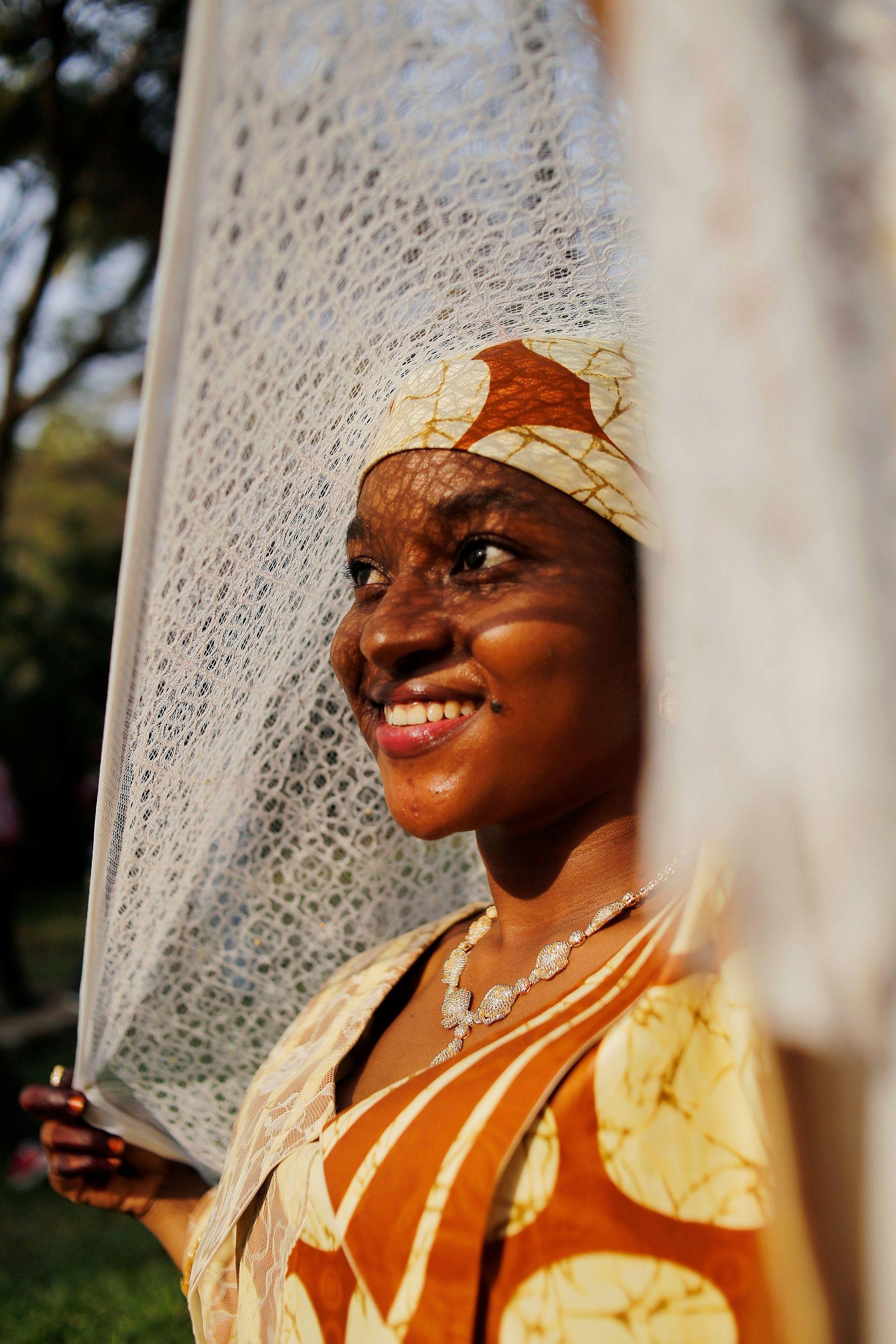 A woman in a headscarf smiling warmly