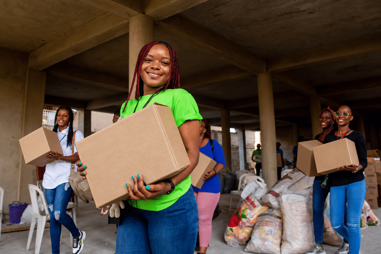 Volunteers carrying food boxes together